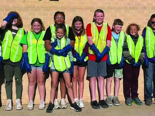 Erick Public School sixth graders pick up trash for Earth Day