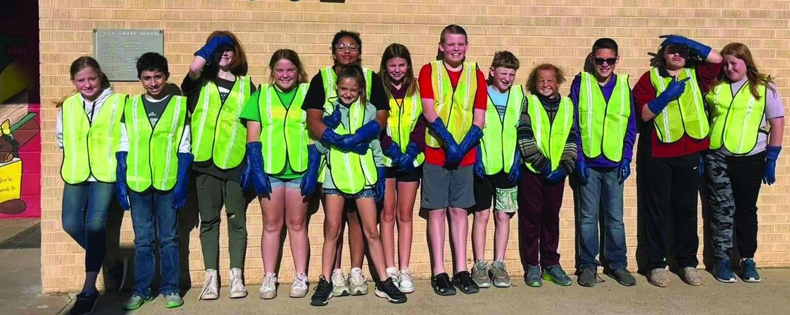 Erick Public School sixth graders pick up trash for Earth Day