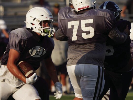 Cooper Garbarino carries the ball for a gain as Fabian Armendariz provides a crucial block. (photo credits to Piper Garbarino).