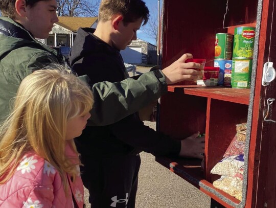 The Elk City 4H kids also visited assisted living centers to spread holiday cheer. ; Members of Elk City 4H re-stocking Giving Boxes throughout the community.