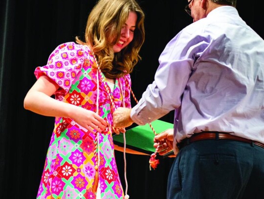 Sayre High School senior Cassidy Crabb receives her National Honor Society cords. Crabb will attend Harvard in the fall