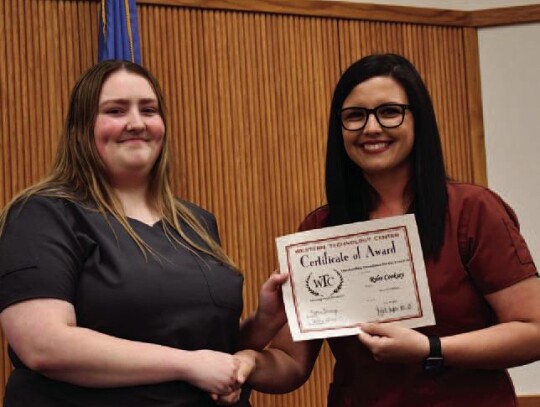 Rylee Cooksey, Elk City High School and WTC-Sayre Health Careers student earned a Perfect Attendance for the Year Award. Health Careers Instructor, Kylee Chapman is presenting Rylee her award.