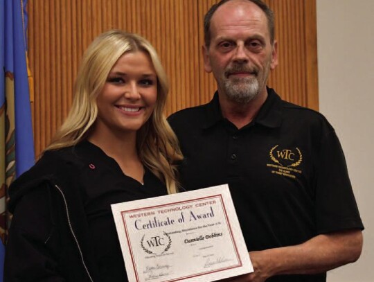 Dannielle Dobbins, adult Willow, and WTC-Sayre Cosmetology student received Outstanding Student for the Year and Perfect Attendance for the Year. Cosmetology Instructor, Bill Helton is presenting Dannielle with her award.